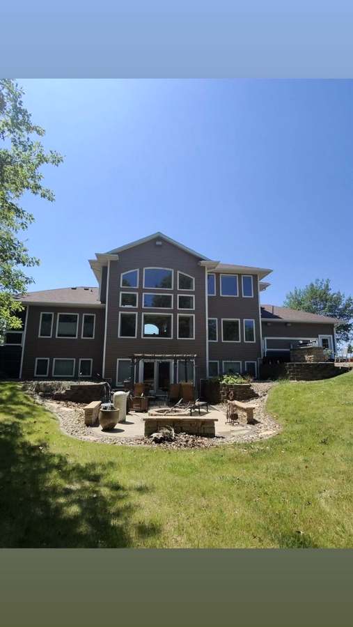 Lakefront home with a full wall of windows after cleaning