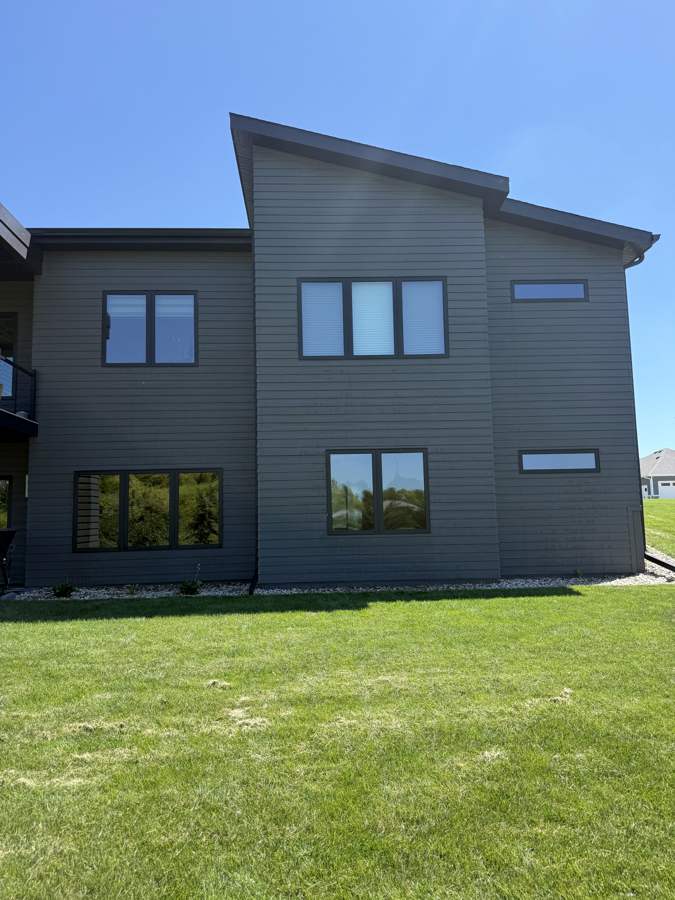 Modern dark two-tone home, rear angle