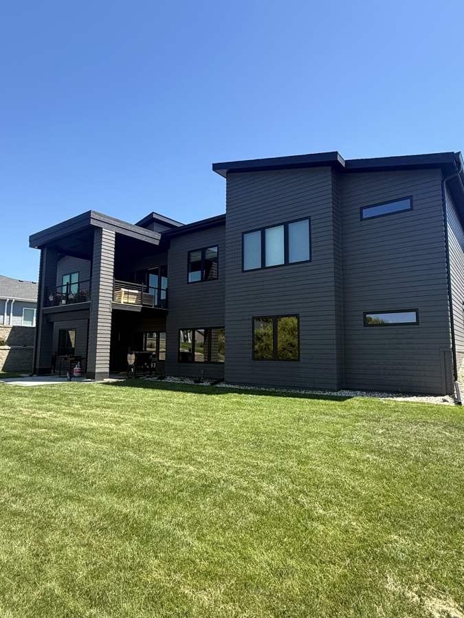 Modern dark two-tone home, rear exterior