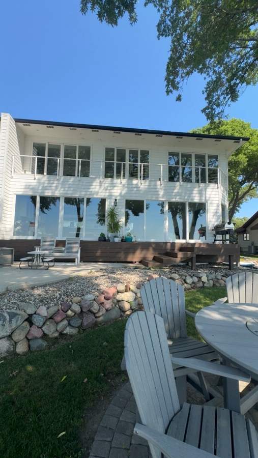 Second lakefront home with a wall of windows and deck after cleaning