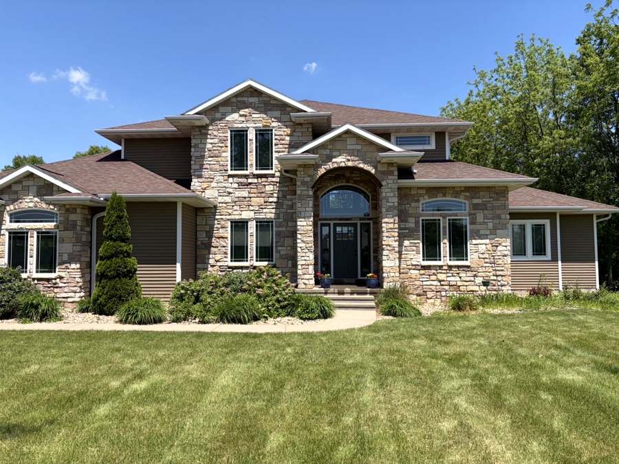 Stone and siding home exterior after house washing