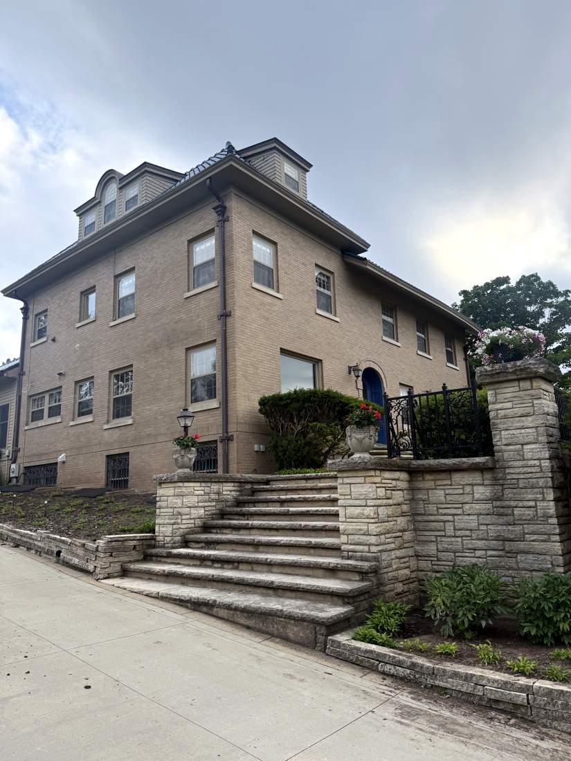Street view of the estate's stone steps and entry
