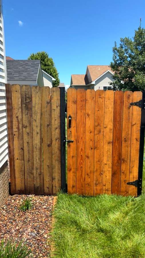 Wood fence gate before and after pressure washing